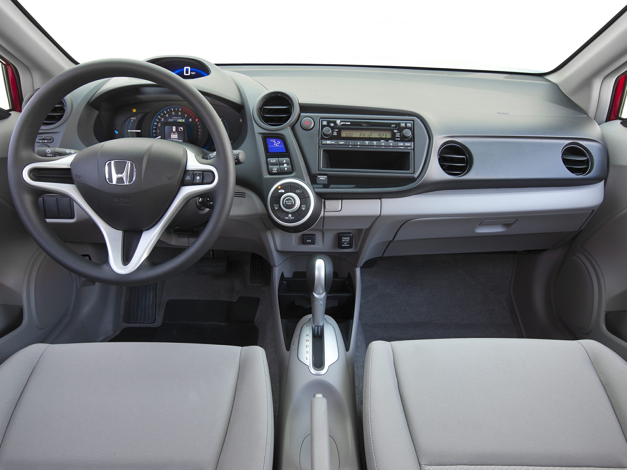 Dashboard and steering wheel with central speedometer and climate controls