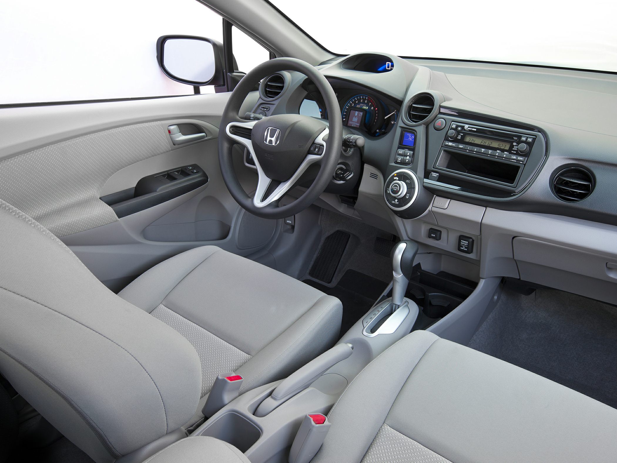 Car interior with dashboard, steering wheel, and center console