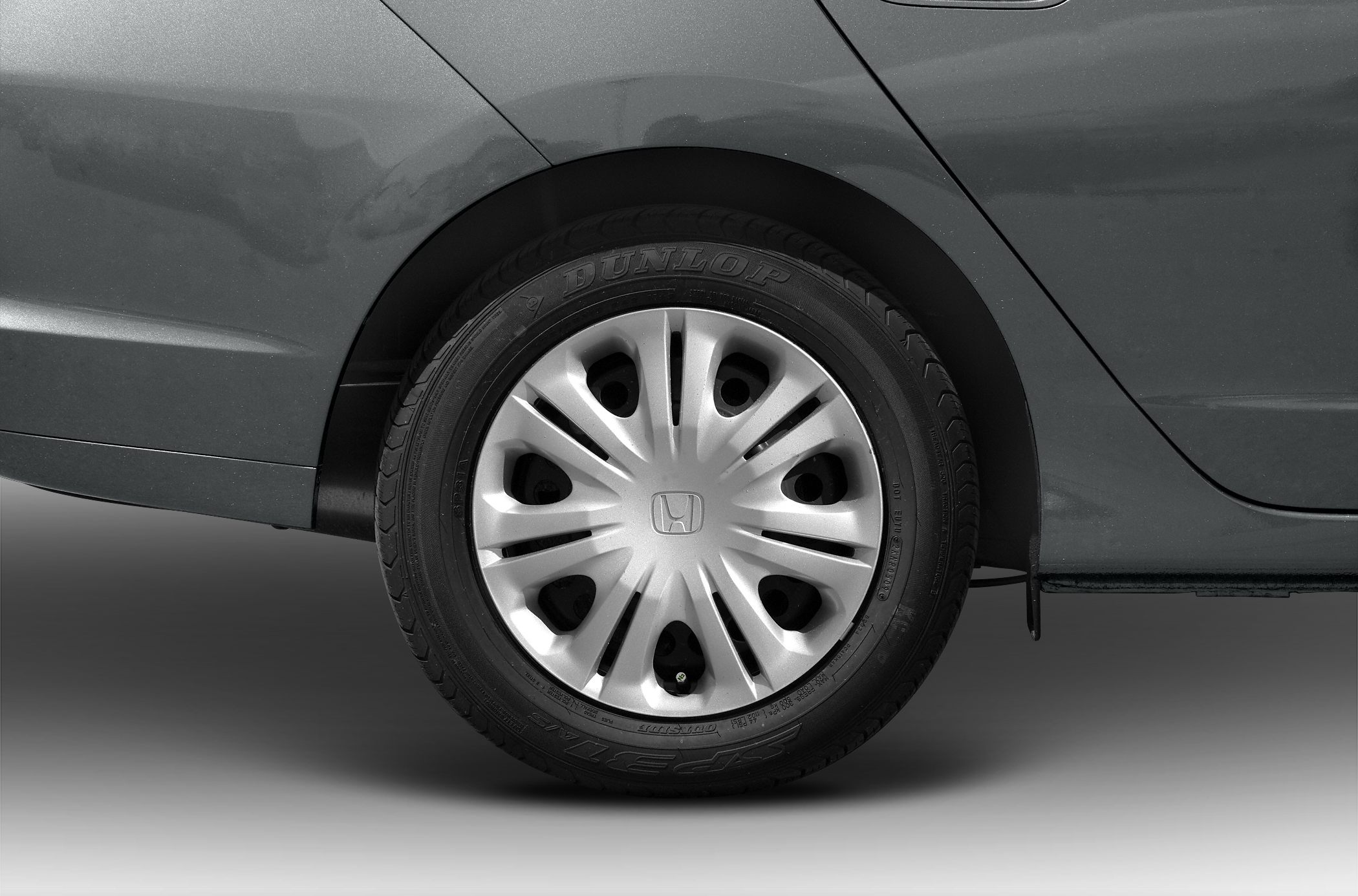 Close-up of alloy wheel with Dunlop tire on rear side