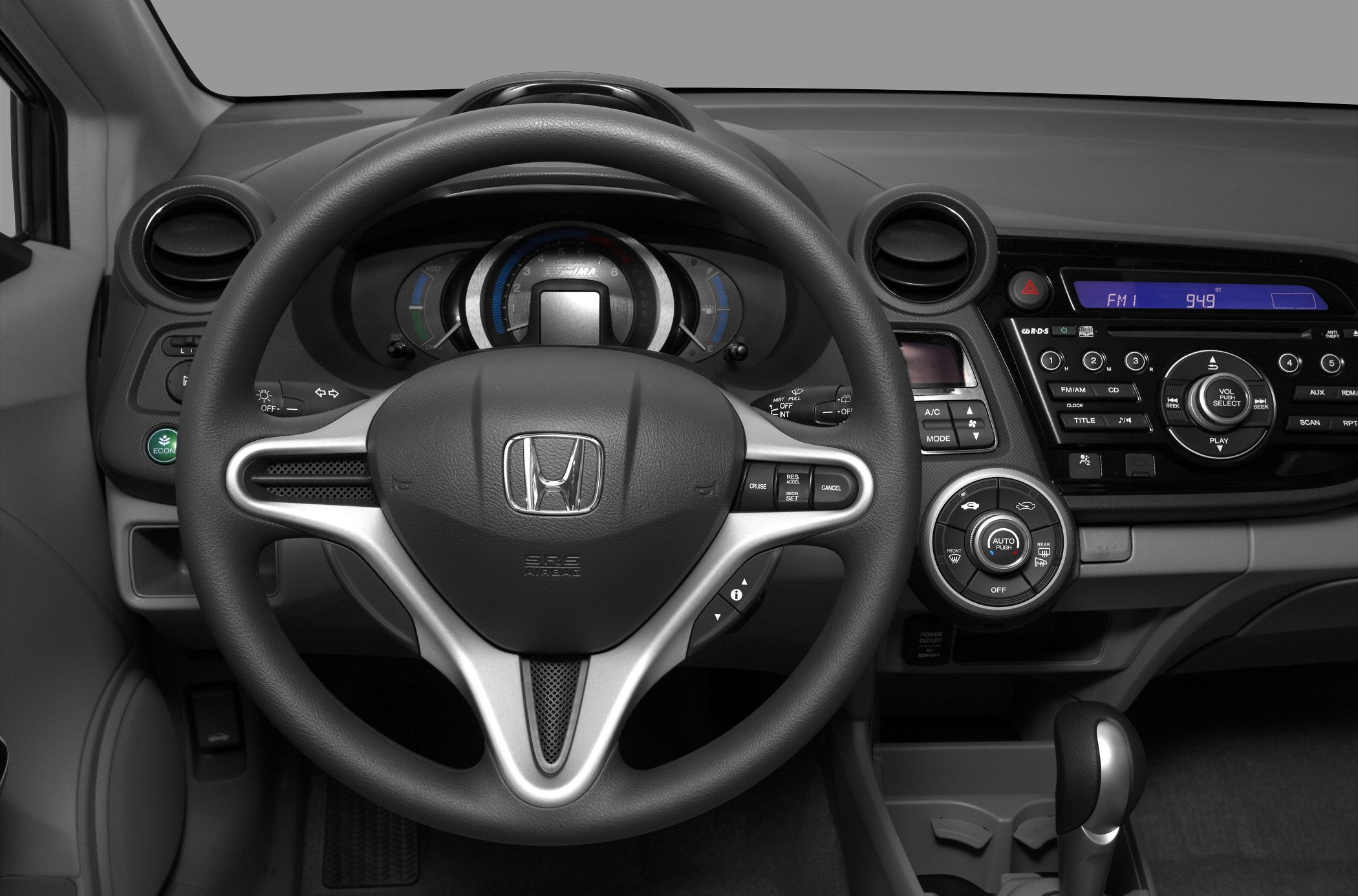 Interior dashboard and steering wheel with control buttons and infotainment display