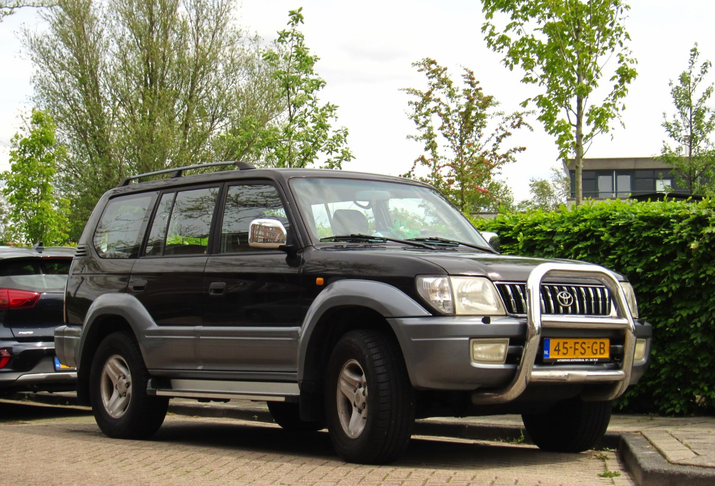 Black SUV with chrome bull bar and off-road tires