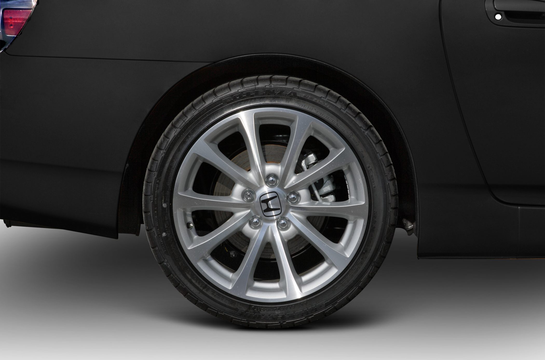 Close-up of alloy wheel with multi-spoke design and visible brake disc