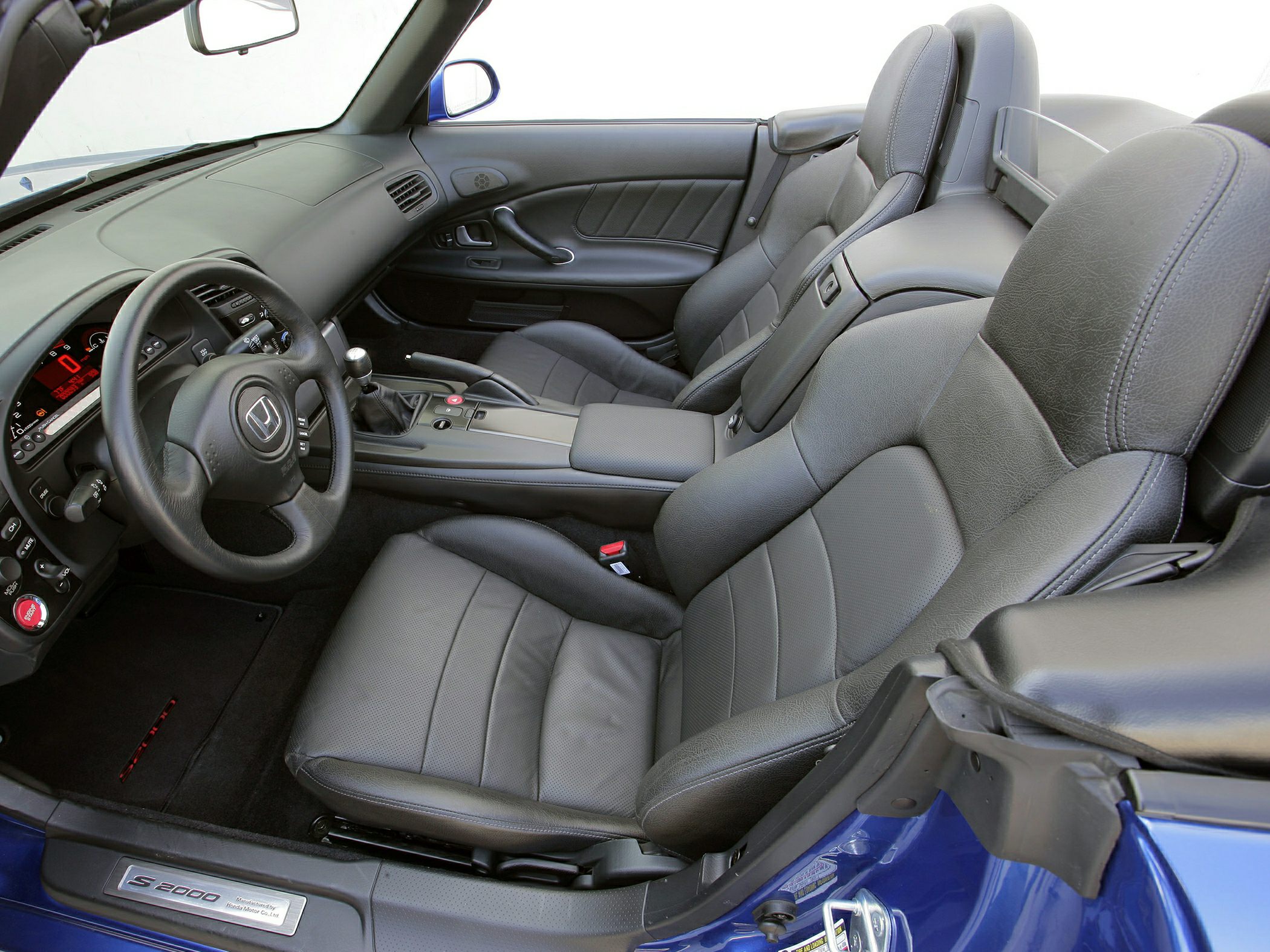 Sporty leather seats and modern dashboard of a convertible roadster interior