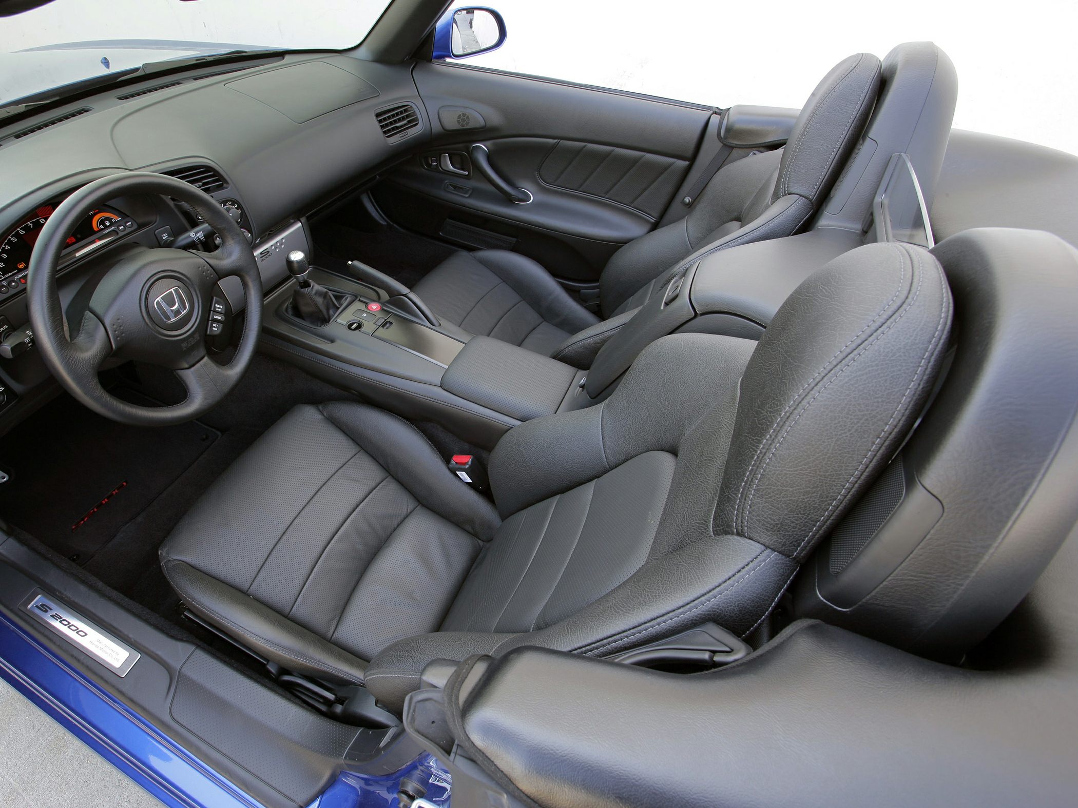 Leather seats with manual gear shifter and sporty dashboard interior