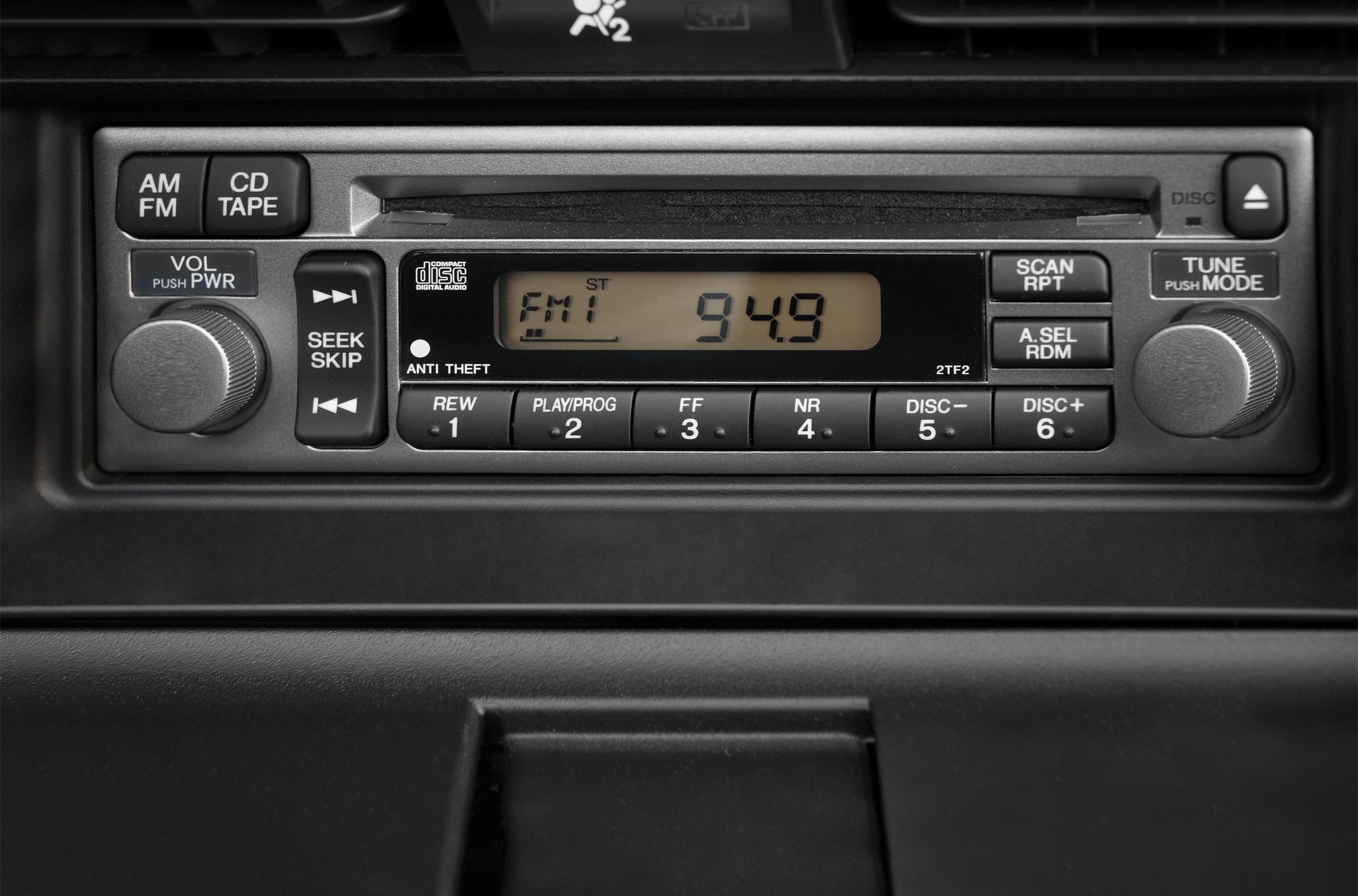 Car radio stereo panel with CD tape player and digital FM display