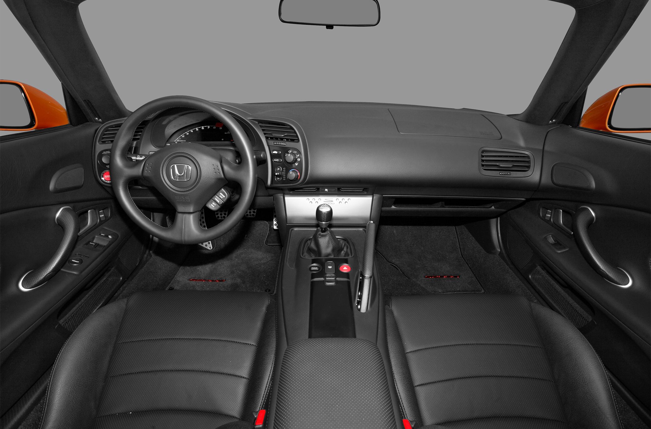 Black leather interior with manual gearshift and sporty steering wheel