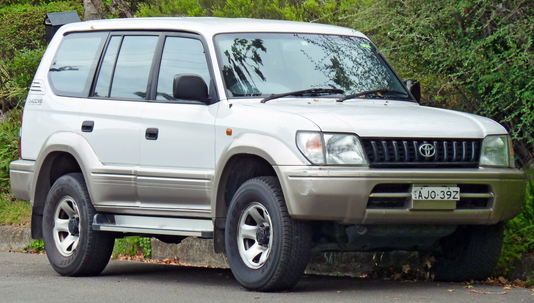 Front and side view of an SUV with rugged tires and dual-tone paint