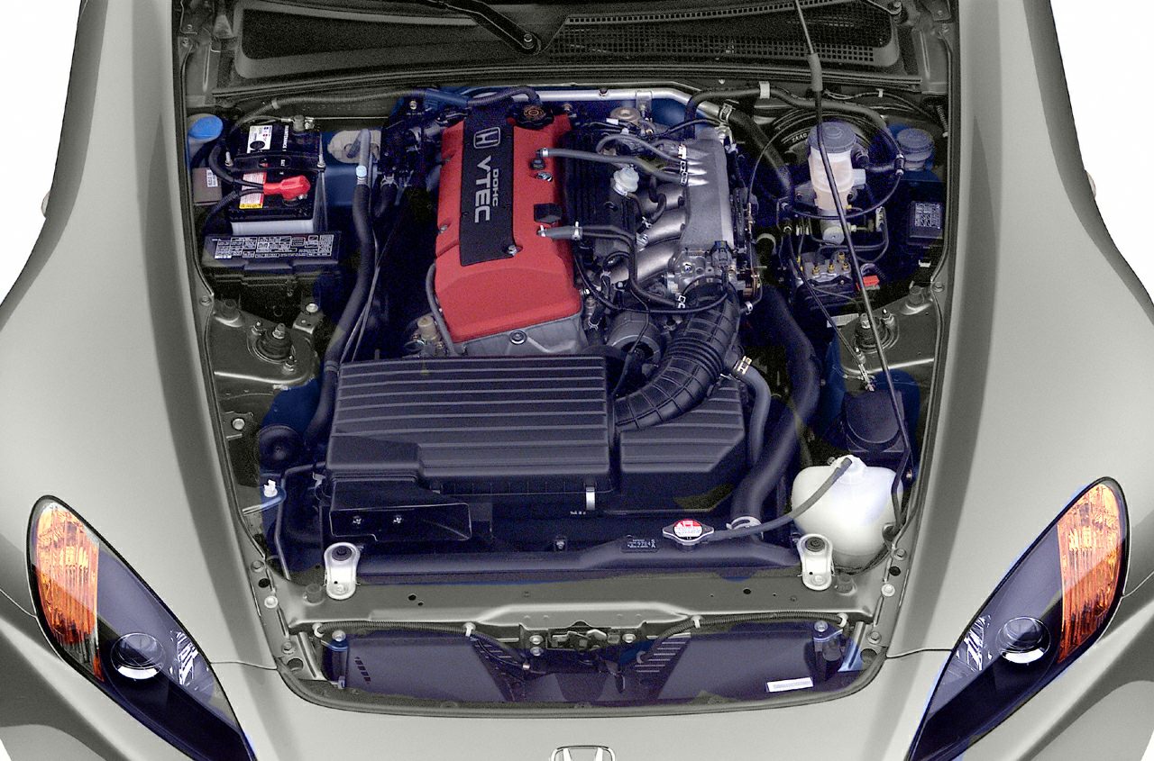 Front engine bay view with red DOHC VTEC and car headlights