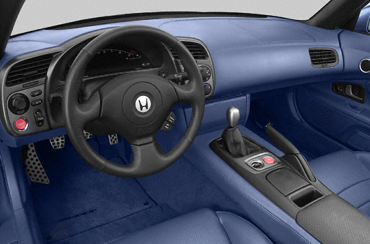 Interior with steering wheel, manual gearshift, and center console