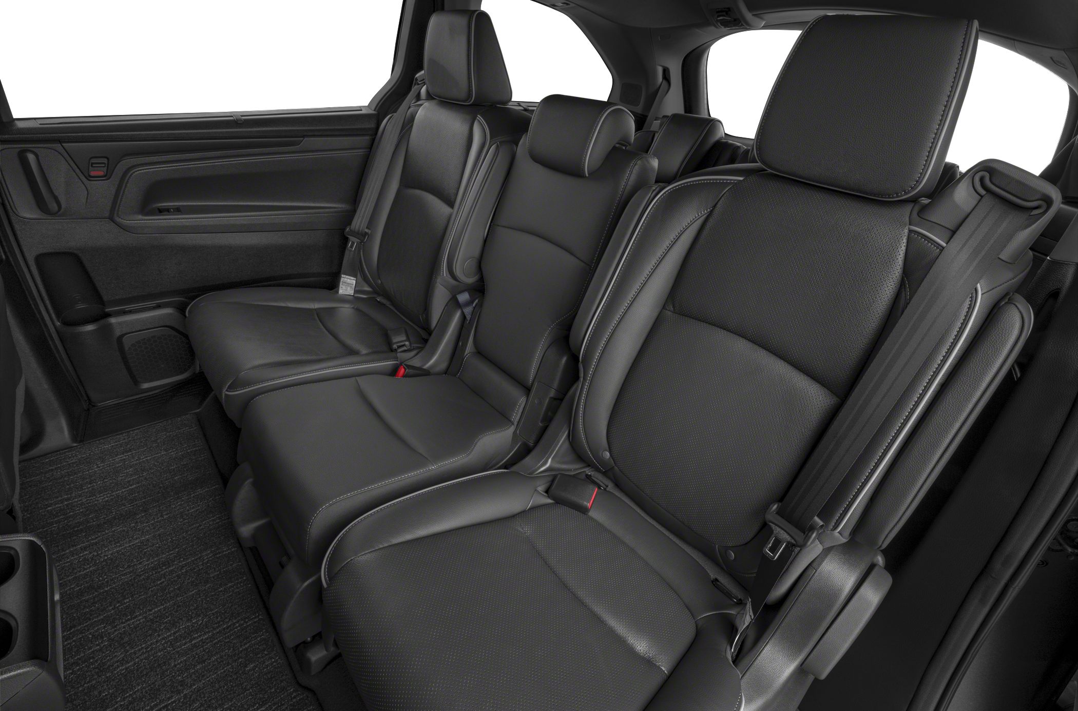 Leather rear seats with headrests and seatbelts in a spacious minivan interior