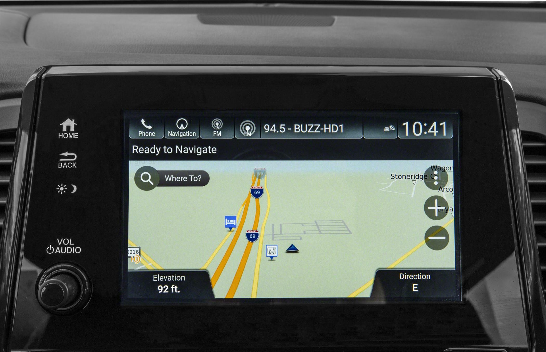 Touchscreen navigation with map, control buttons, and audio knob.