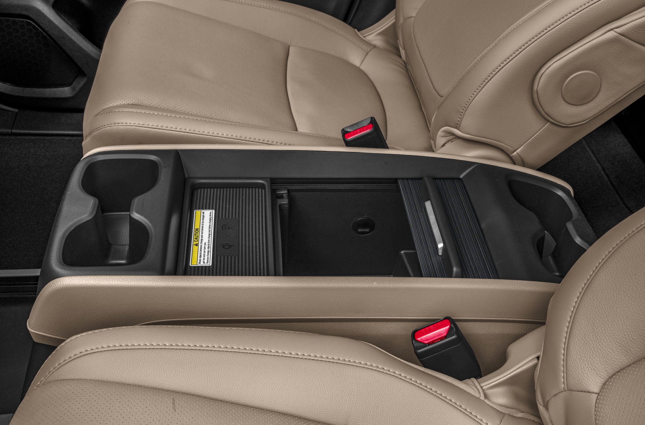 Beige leather seats with center console and dual cup holders