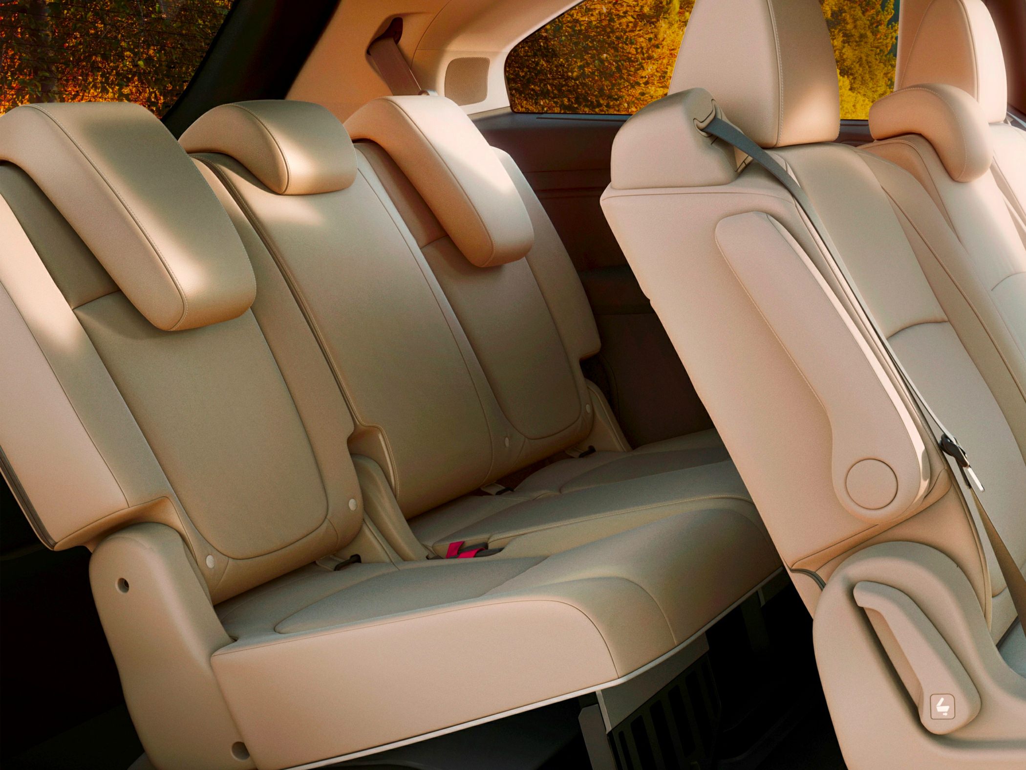 Beige rear seat row with headrests and folding mechanism