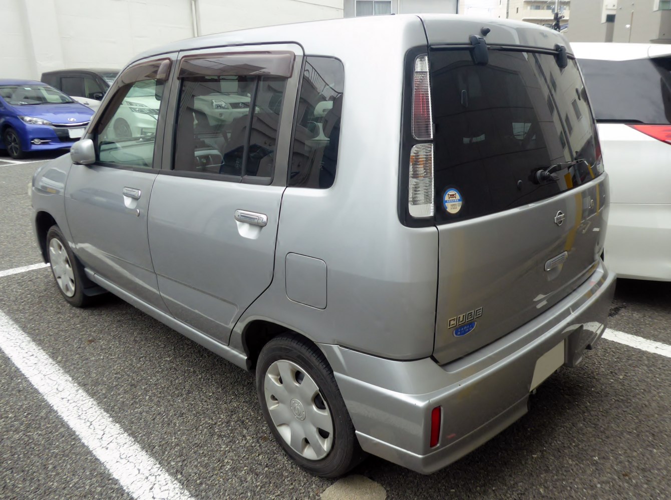 Rear and side view of compact, boxy hatchback with vertical taillights