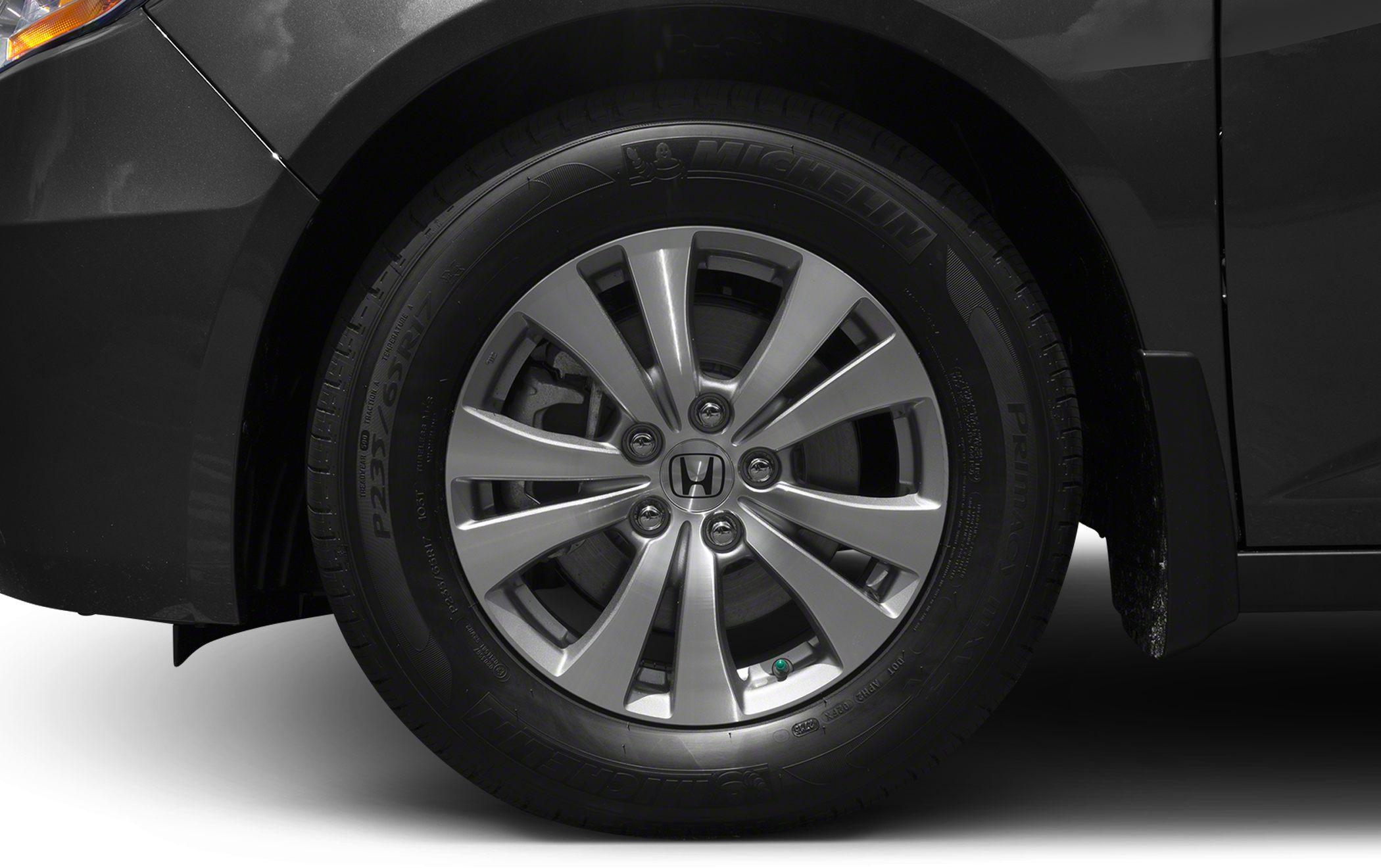 Close-up of alloy wheel with Michelin tire on minivan.