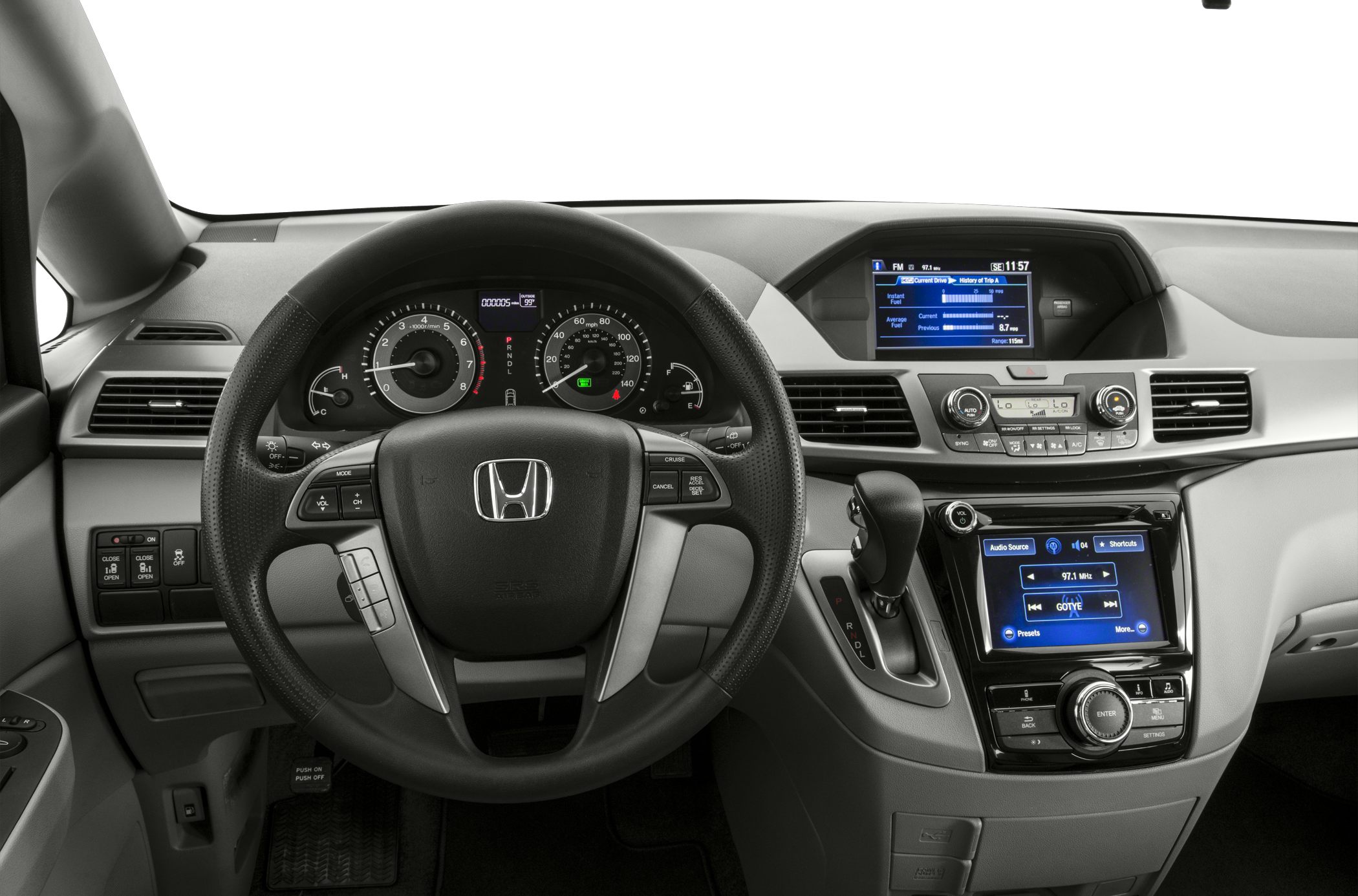 Steering wheel, instrument cluster, and dual infotainment displays.