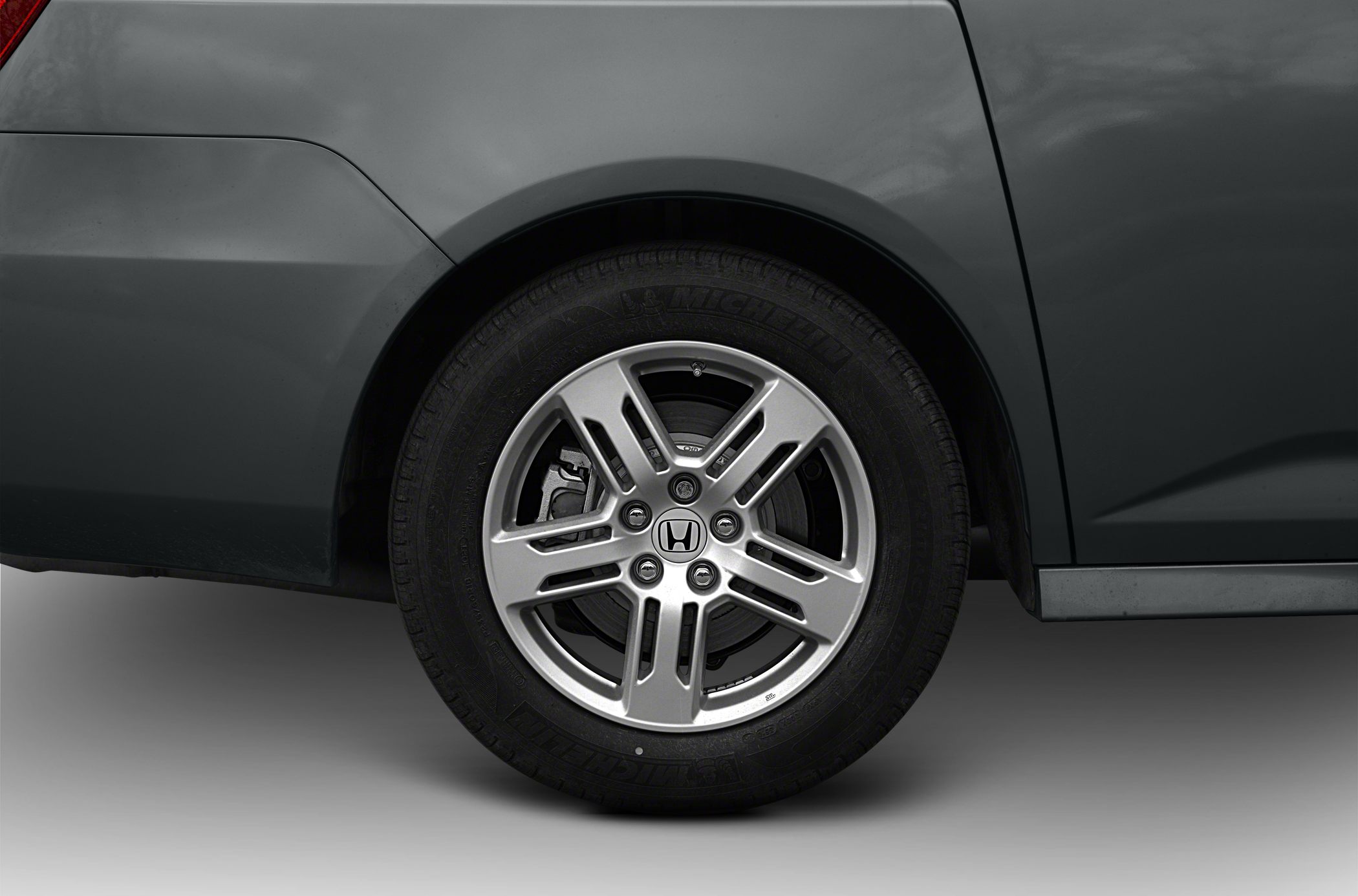 Close-up of minivan rear wheel with silver alloy rim and Michelin tire