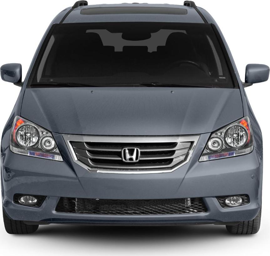 Front view of a minivan grille, headlights, and fog lights