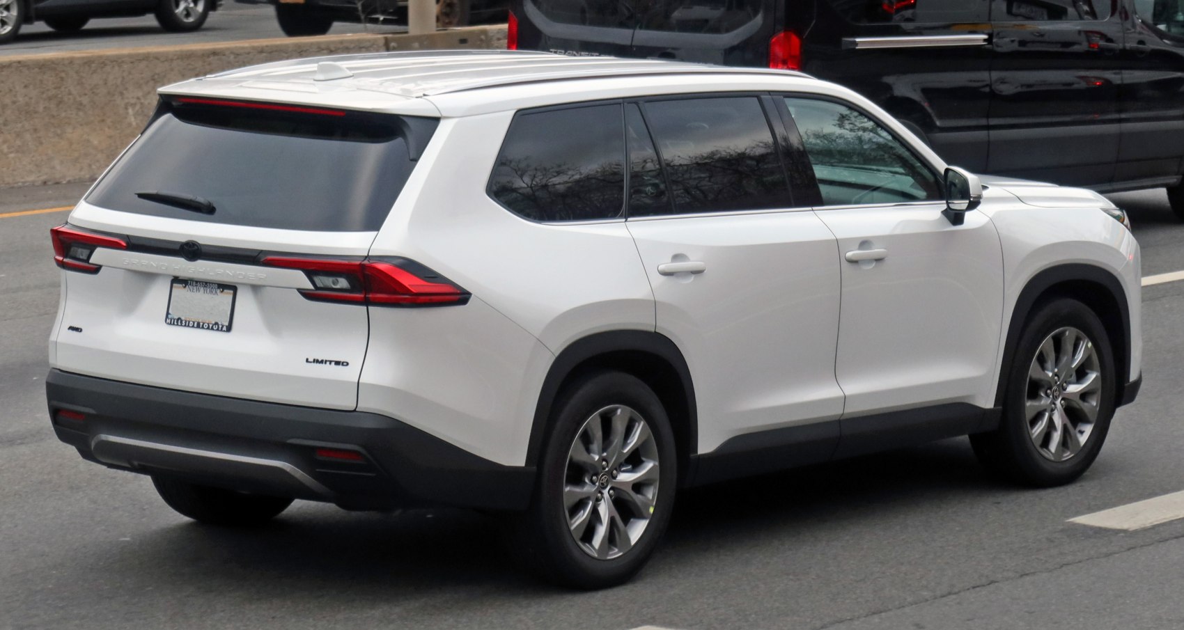 Rear side view of a modern white SUV with alloy wheels and tinted windows
