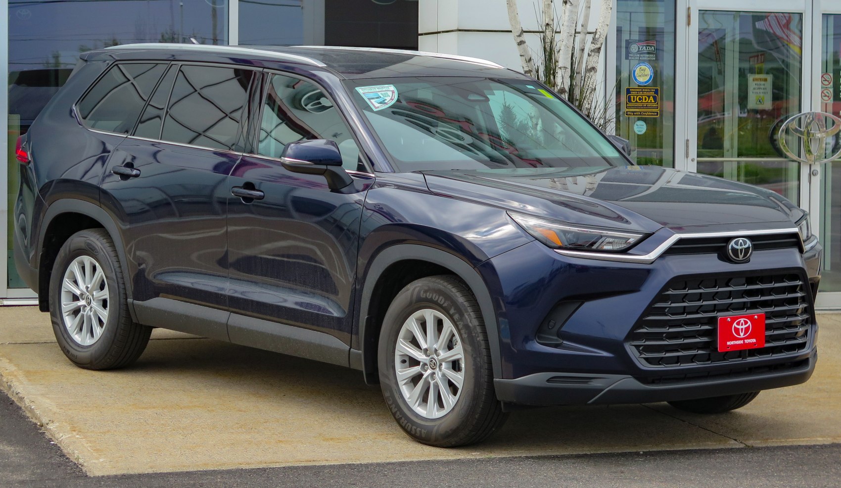Front side exterior view of a modern SUV with bold grille and sleek headlights