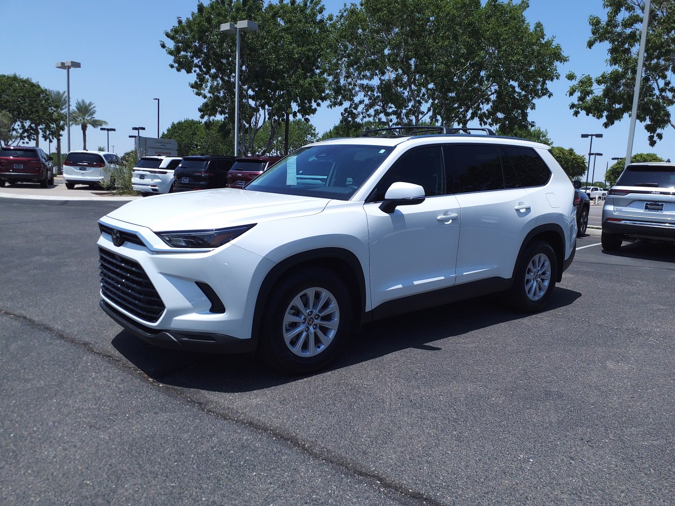 Angular front grille and sleek headlights in side-front view.