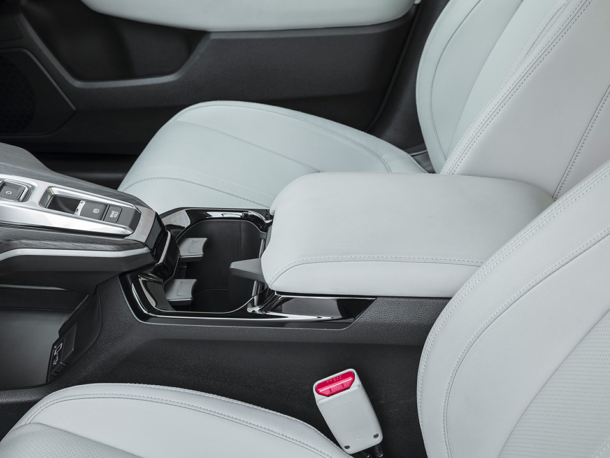 Center console with gear selector buttons and light-colored leather seats