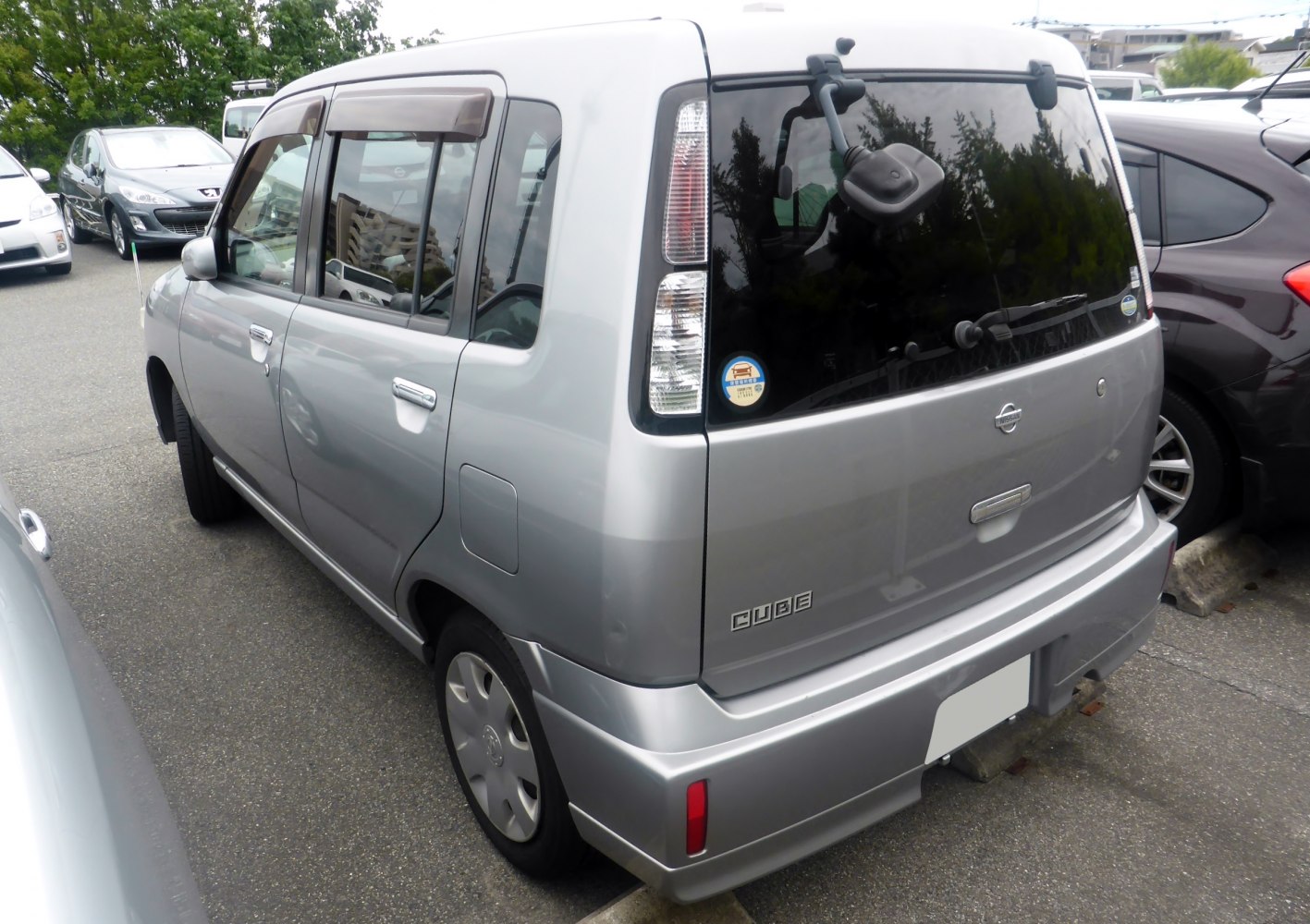 Rear side view showing boxy shape and vertical tail lights.