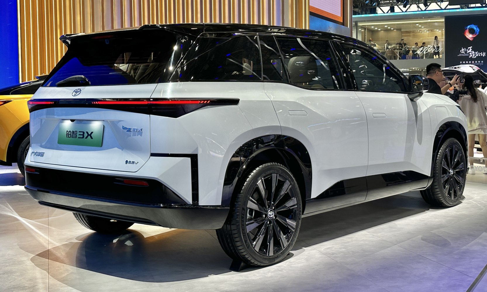 Rear and side view of a white SUV with black roof and sleek LED taillights