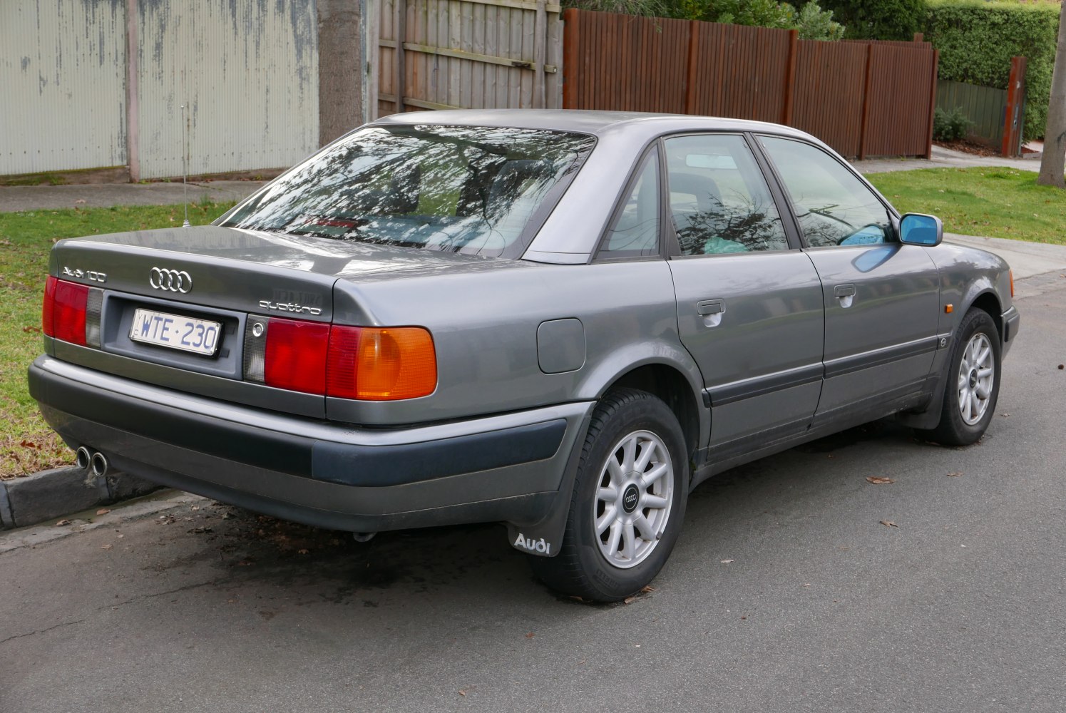 Rear left view of classic sedan with distinctive taillights and alloy wheels