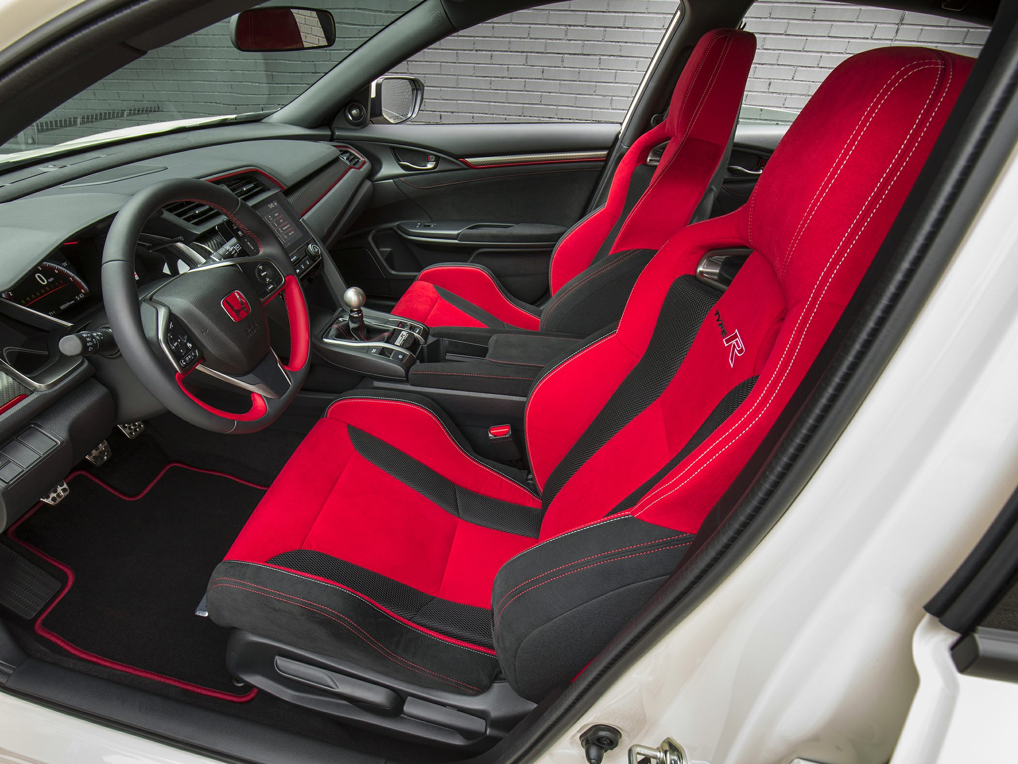 Red and black sport seats with manual transmission and sporty cockpit
