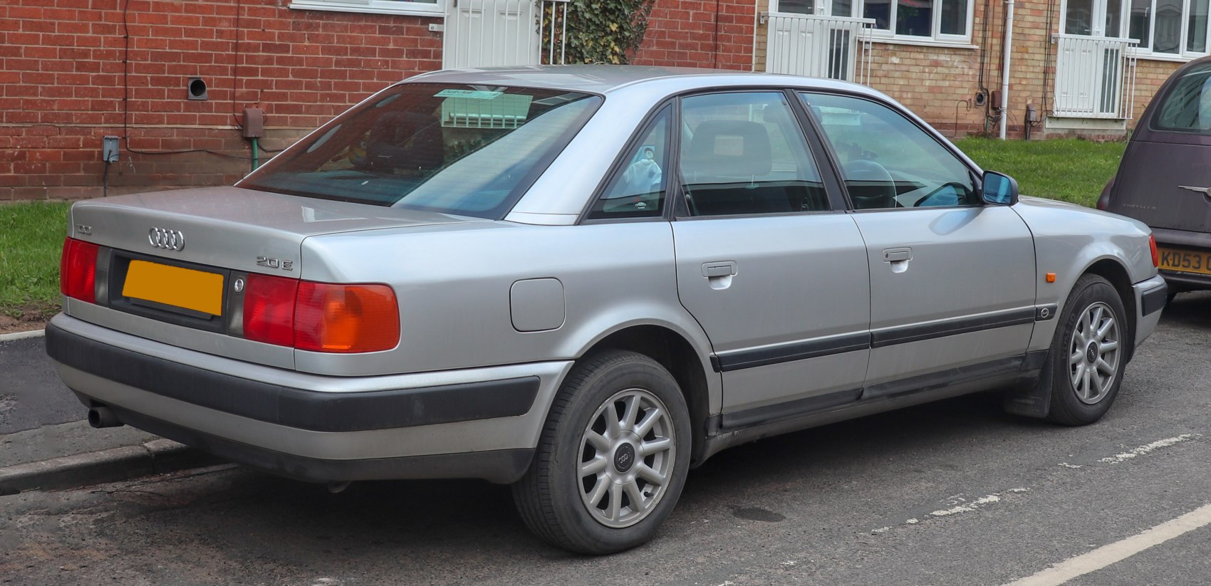 Silver sedan rear side with tail lights and alloy wheels