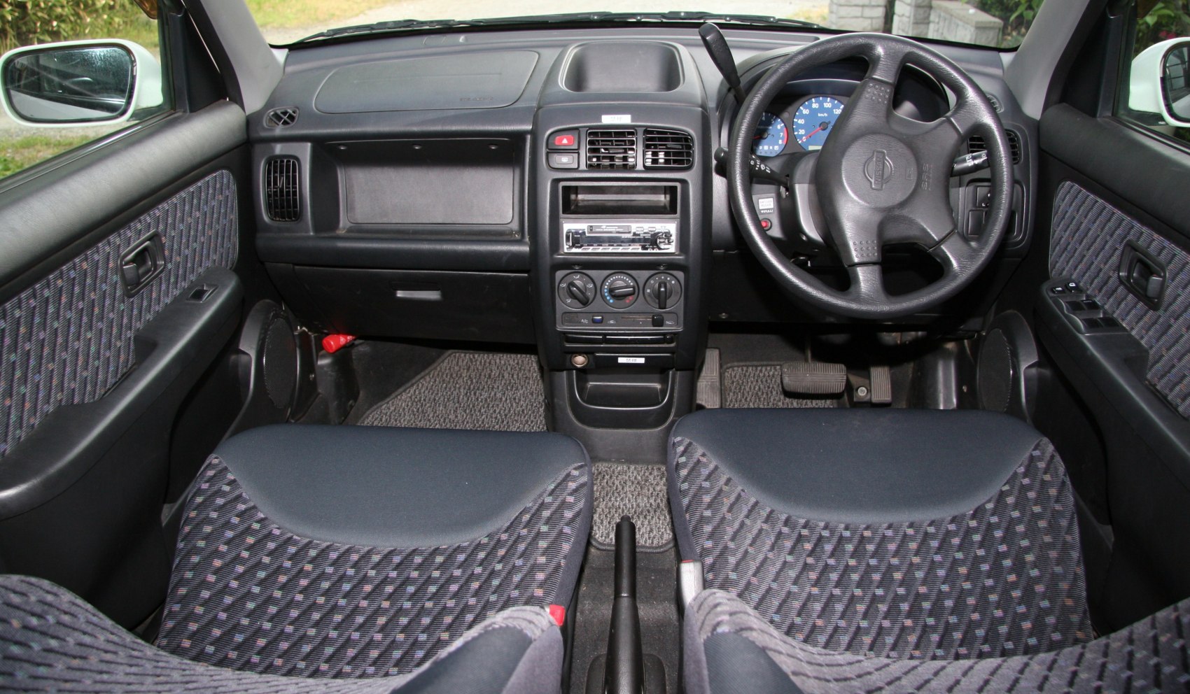 Dashboard and fabric seats with steering wheel and control panel view