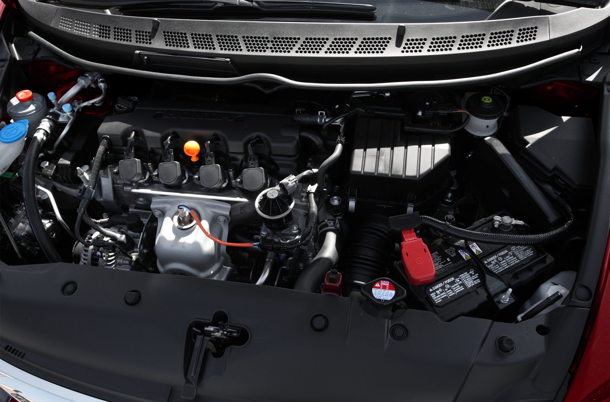 Detailed view of a compact automotive engine bay with visible components and wiring