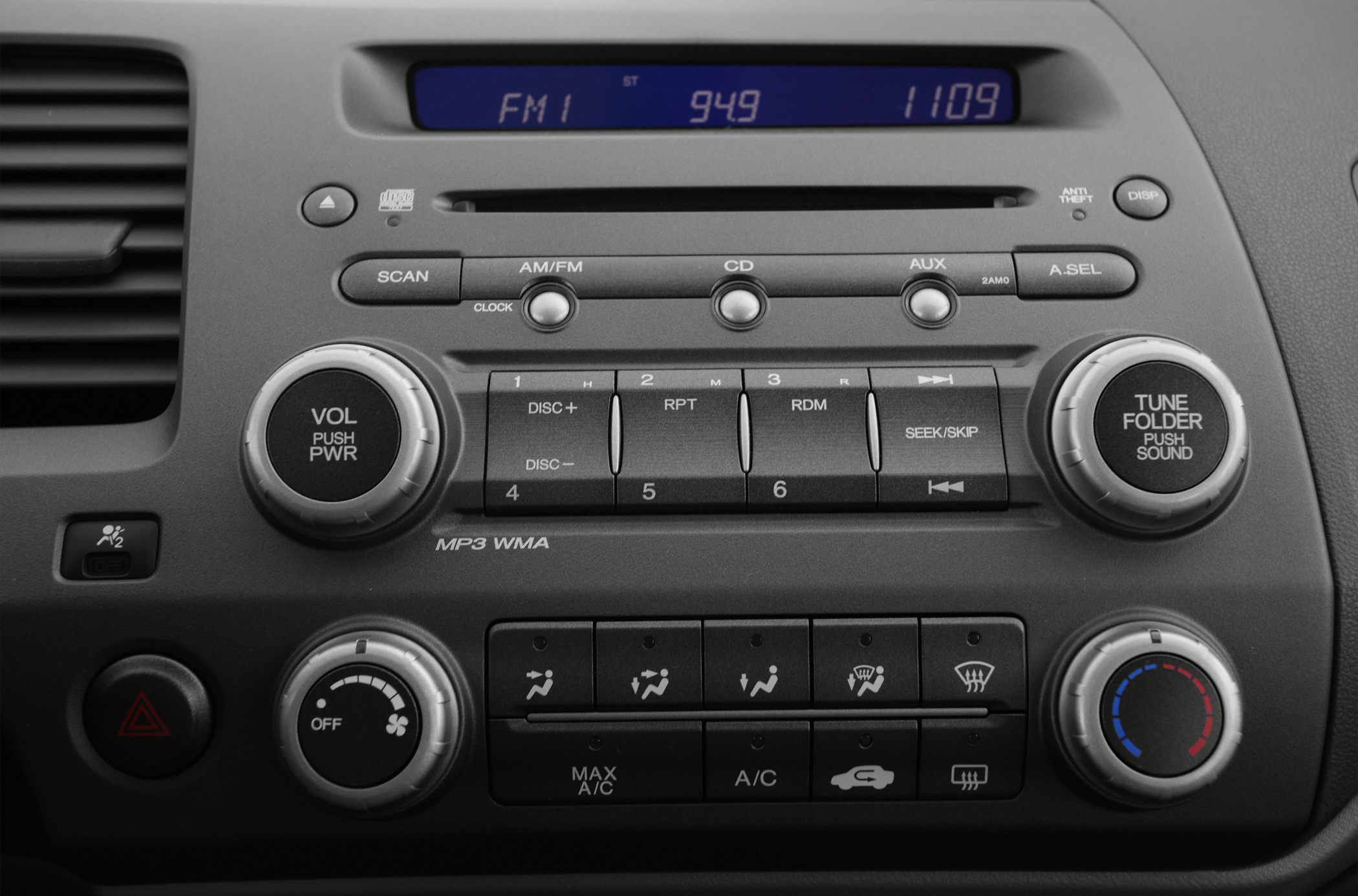 In-dash audio system and climate controls with buttons and knobs