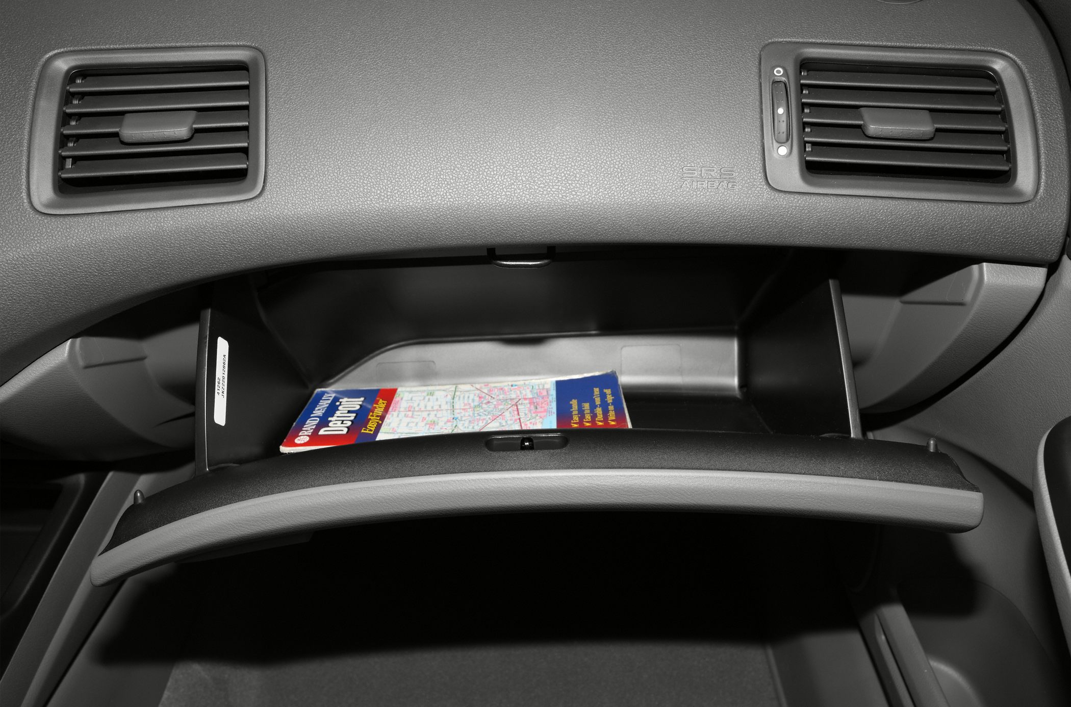 Open glove compartment with map and dashboard ventilation vents