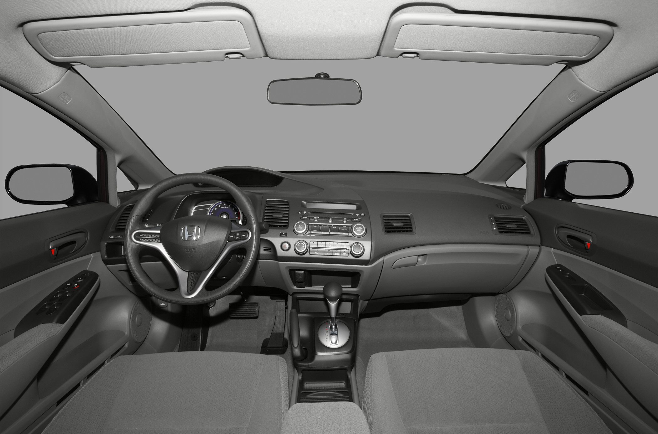 Car interior with dashboard, steering wheel, and center console.