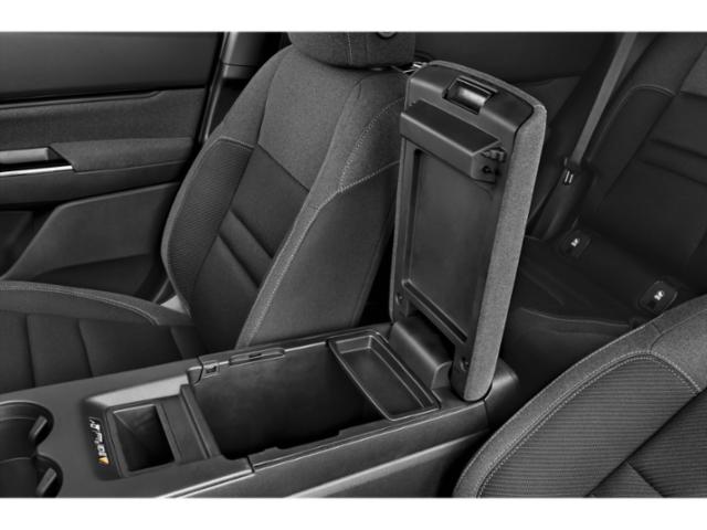 Interior center console storage compartment with armrest in a vehicle