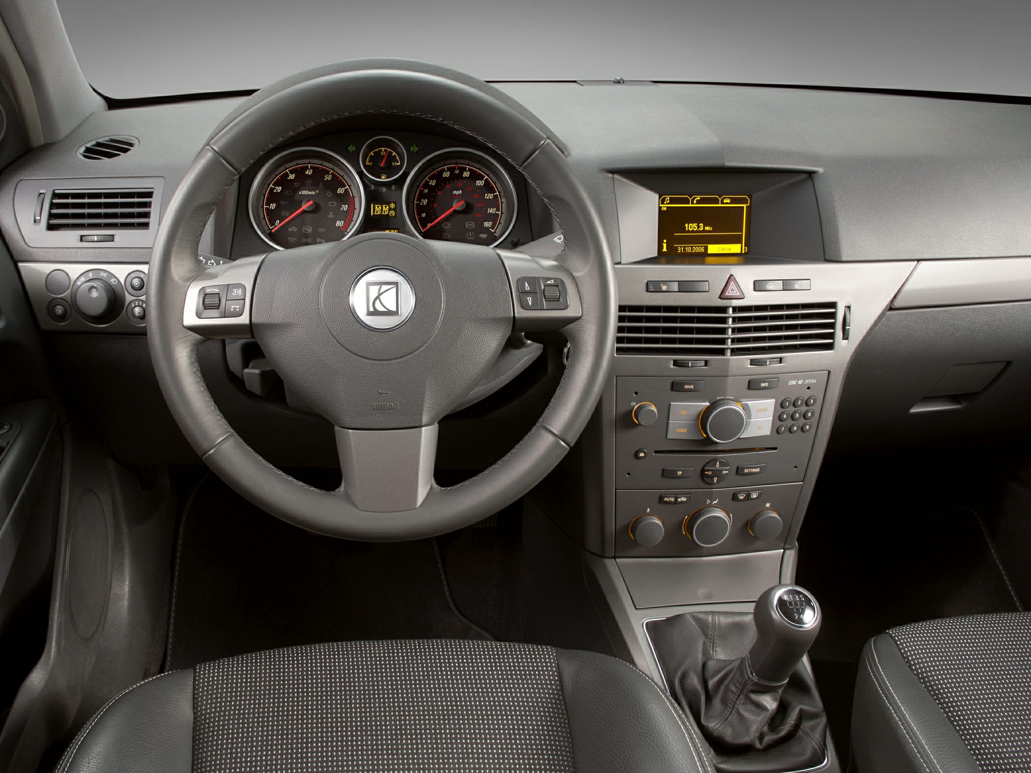 Dashboard, steering wheel, and manual gear shift interior elements