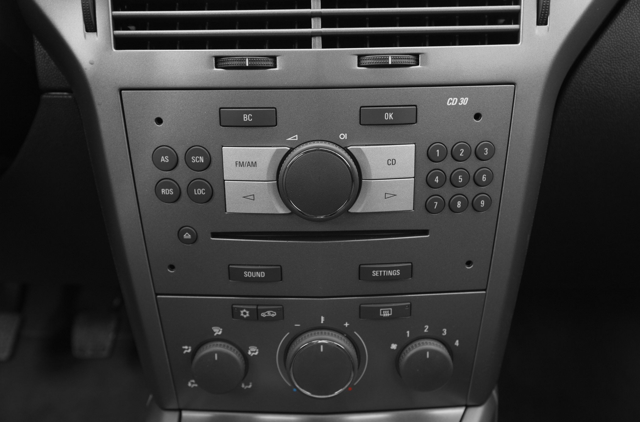 Car audio system and climate control panel with radio, CD player, and temperature knobs