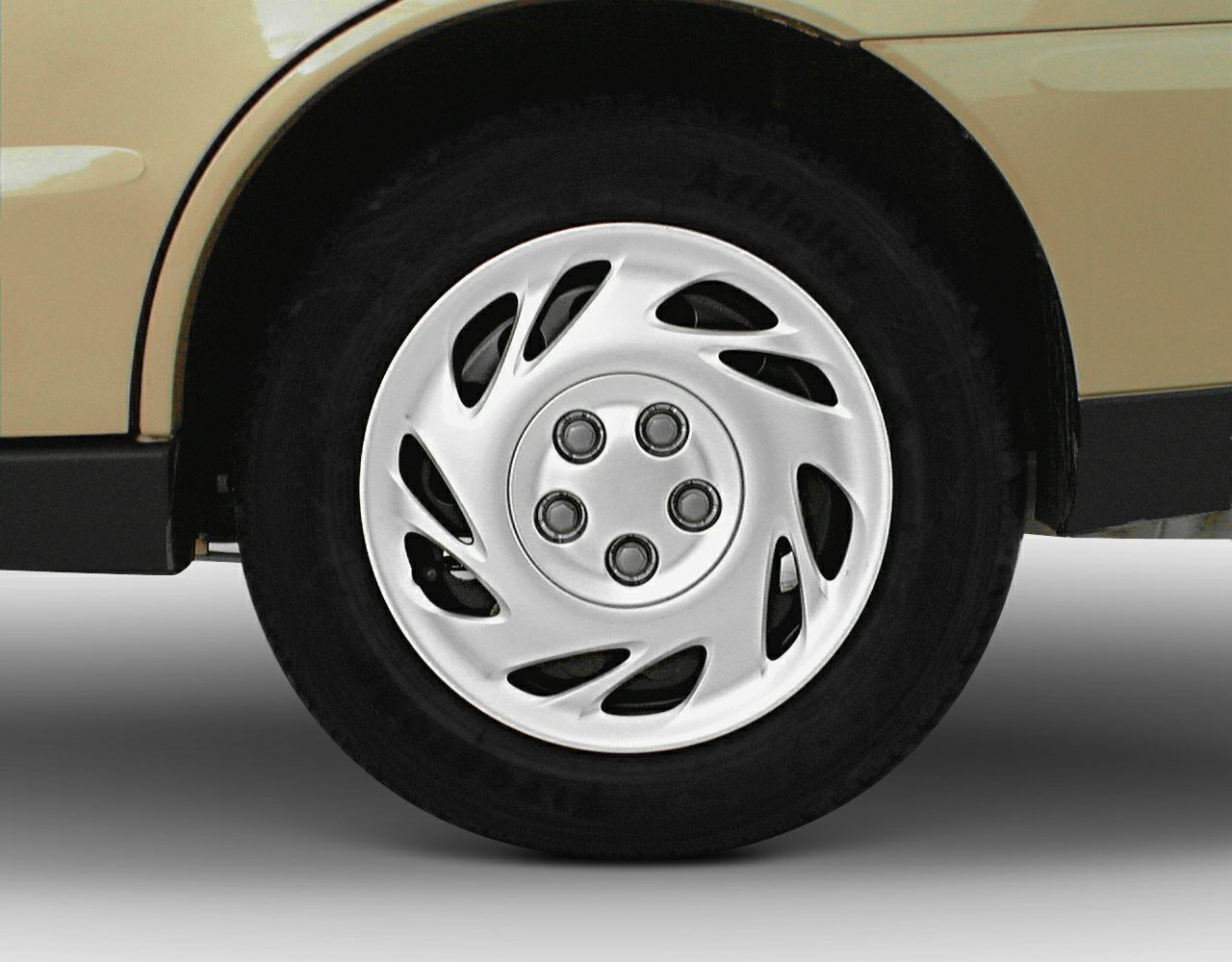 Five-spoke swirl pattern wheel with tire closeup