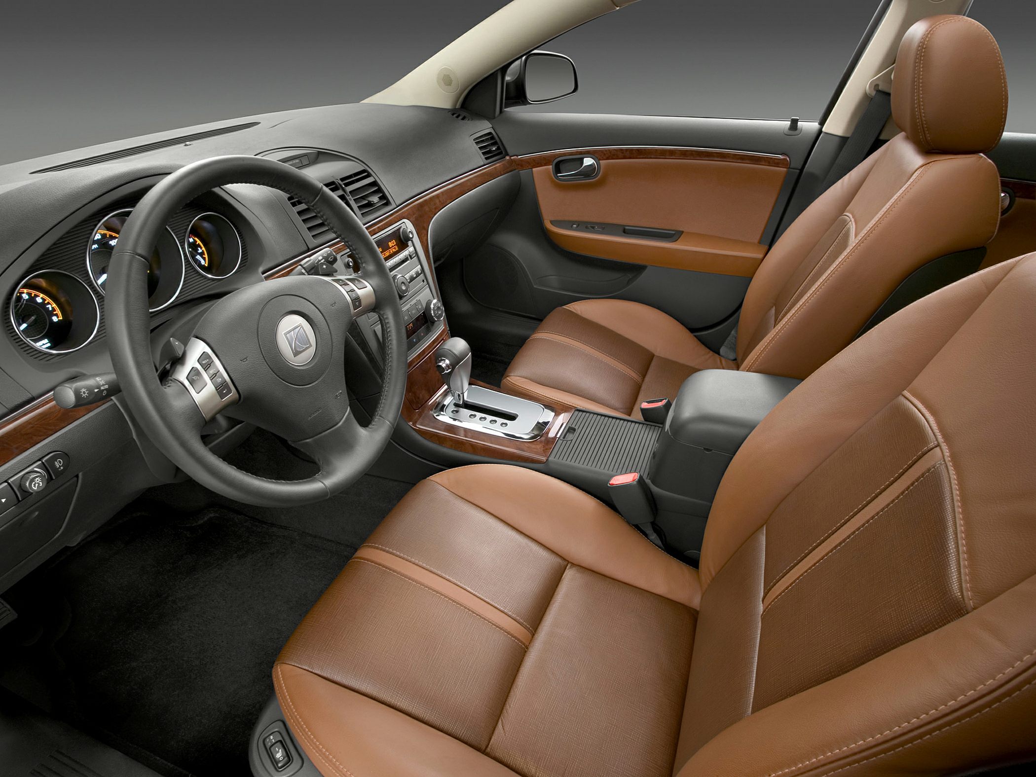 Brown leather seats with wood trim dashboard and automatic gear shift
