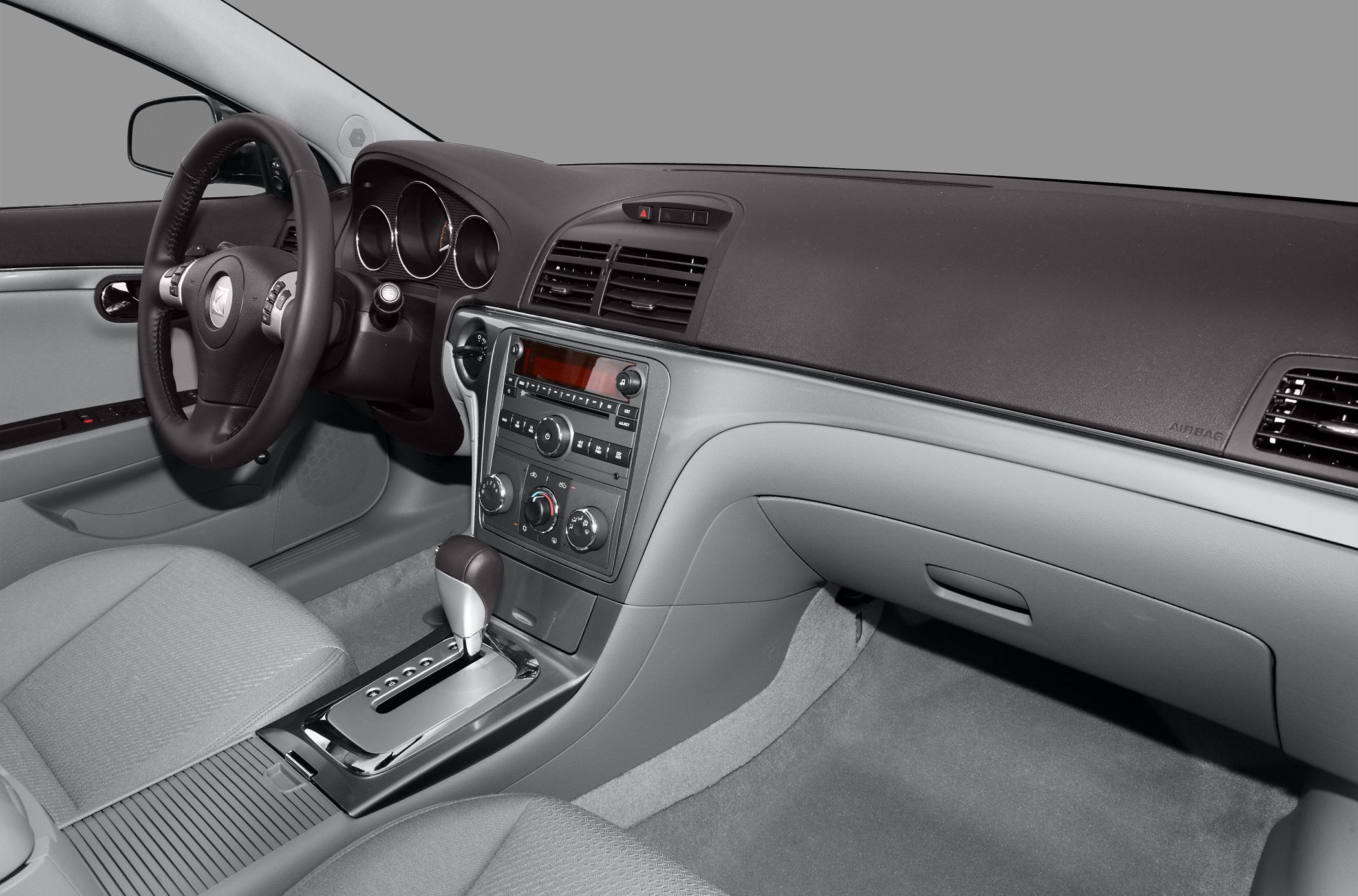 Modern dashboard and automatic gear shift with climate controls.