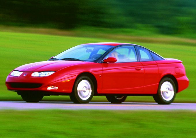 Red coupe on road with sleek aerodynamic design in motion