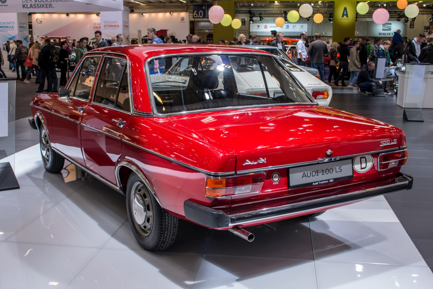 Rear view of a red vintage sedan with chrome trim and classic 1970s design.