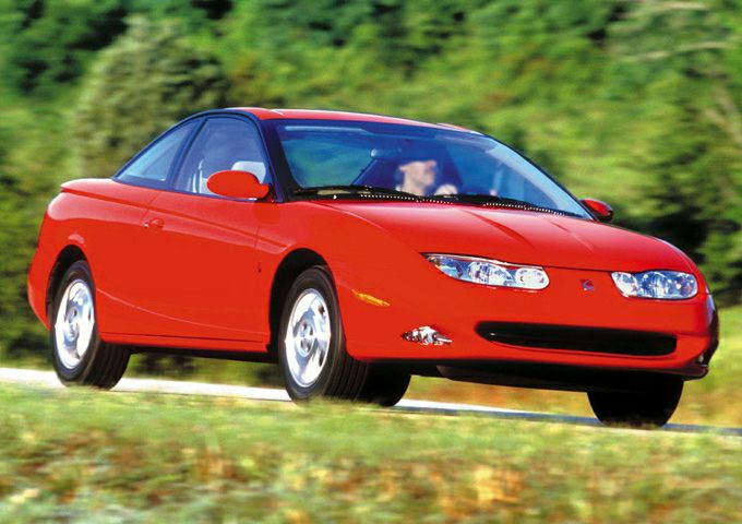 Red sports coupe with sleek headlights and aerodynamic shape