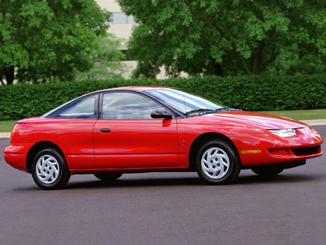 Red coupe with pop-up headlights and sleek aerodynamic body.