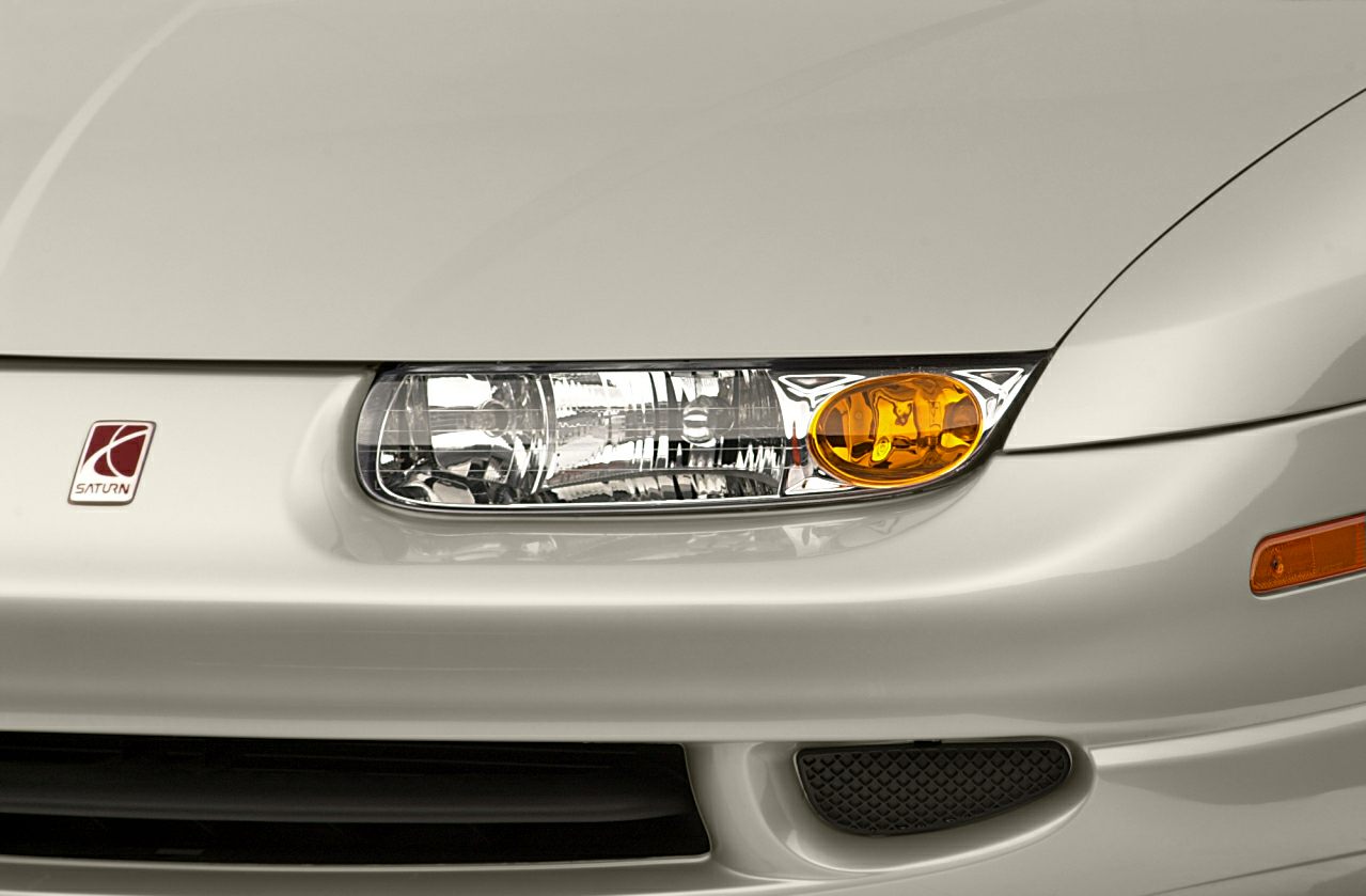Close-up of front headlight and amber turn signal with emblem