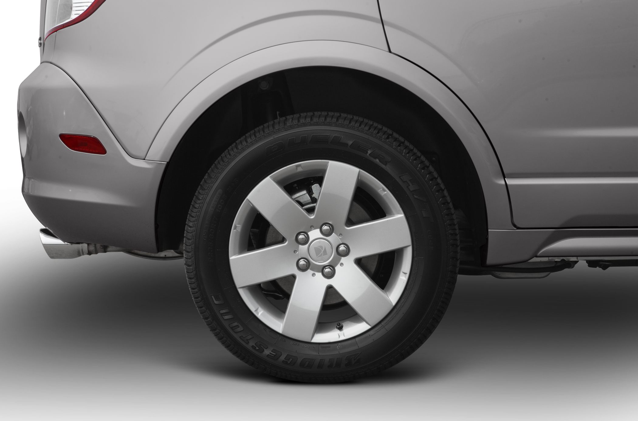 Alloy wheel and rear fender close-up with Bridgestone Dueler tire