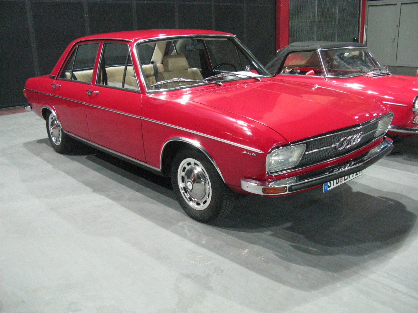 Red classic 1970s four-door sedan with chrome trim and vintage styling