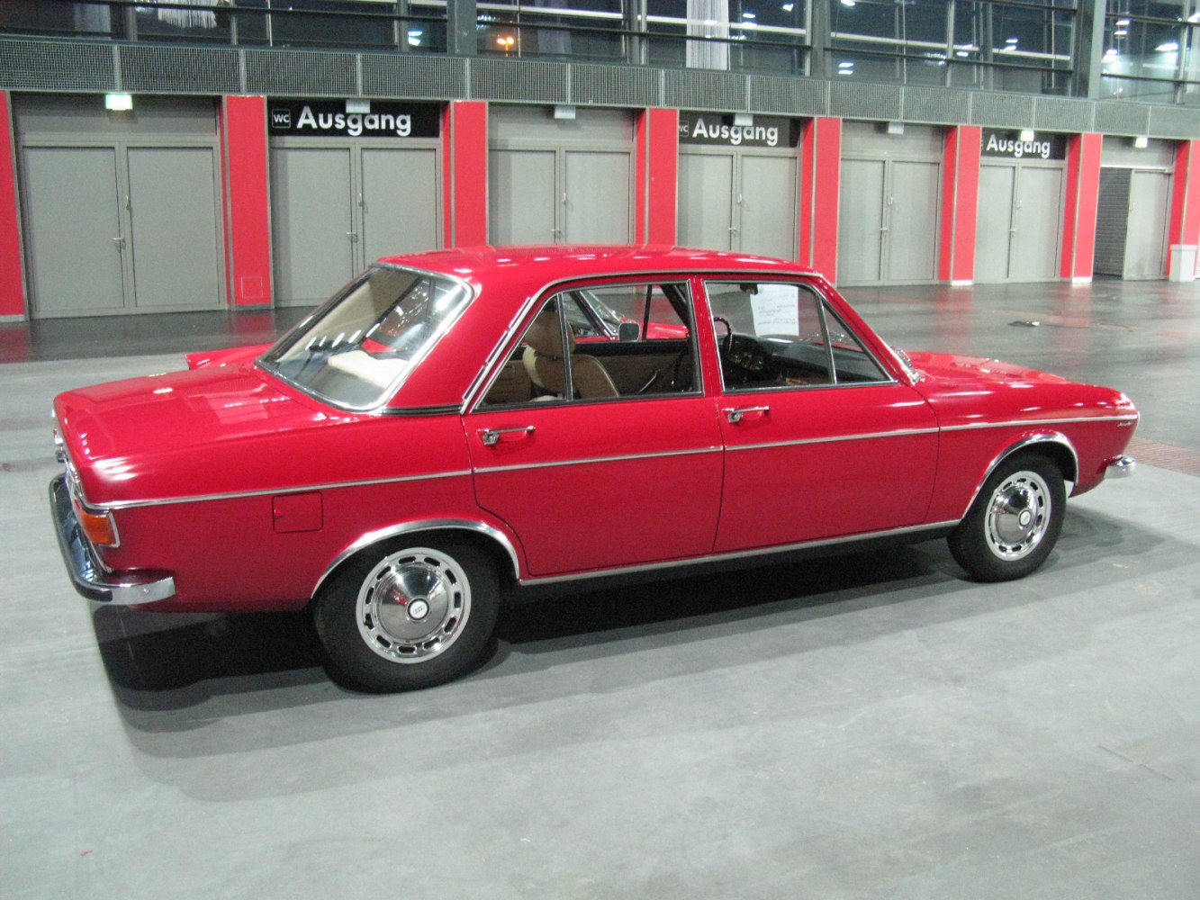 Red classic 1973 facelift sedan with chrome trim and vintage steel wheels.